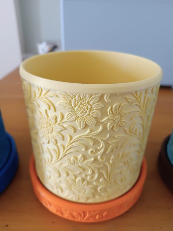 Maceta con motivos florares y plato con diseño a juego